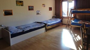 A dormitory room with bunk beds, a desk, and a window. - Gurtendörfli by Interhome (Wabern)
