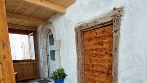 A rustic wooden door, a potted plant, and a stone archway. - Giselas Ruheplatz by Interhome (Liesberg Dorf)