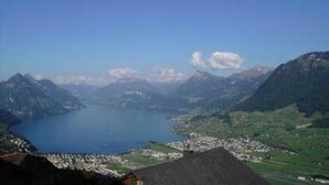 A mountainous landscape with a lake and a small town.