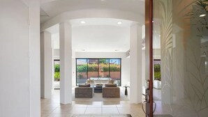 A modern hotel lobby with a spacious seating area, a glass wall, and a view of the outdoors. - Marvelous 4-bed resort style house with panoramic Mountain Views in La Quinta (La Quinta)