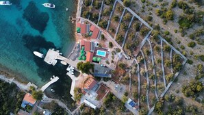 An aerial view of a coastal property with a marina, a swimming pool, and a stone pathway. - Strandhaus Sofia - Ferienanlage Bain, Žut - Kornati by Interhome (Dragišina)