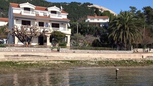 A boat named 'LANA' docked near a waterfront with buildings in the background. - Wohnung 1 mit Meerblick by Interhome (Rab/Rab)