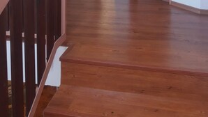 A wooden staircase leading to a door with a clock on the wall. - Wellness Villa near Prague - all inclusive by Interhome (Vranov)