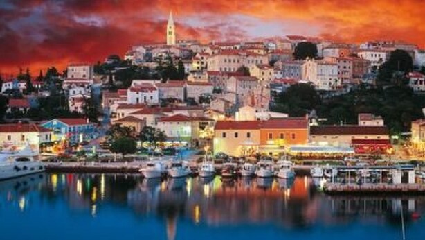 A coastal town with a prominent church tower, waterfront buildings, and a marina with boats. - Villa "Bella" by Interhome (Vrsar)