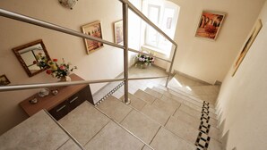 A staircase with a metal railing, a wooden console table with decorative items, and a mirror. - Villa "Bella" by Interhome (Vrsar)