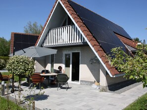 A house with a sloped roof, a balcony, and solar panels. - Haus Reiher am Lauwersmeer by Interhome (Anjum)
