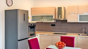 A modern kitchen with a refrigerator, oven, microwave, and sink. - Appartement "Appartement Sarah" mit Balkon by Interhome (Buzdohanj)