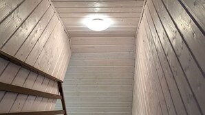 A wooden staircase with a metal handrail, leading to a ceiling with a circular light fixture. - Trebor"-Häuser in einem eingezäunten Gebiet by Interhome (Miedzyzdroje)