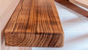 A wooden bench with a natural wood finish, positioned against a wall with horizontal wooden slats. - Trebor"-Häuser in einem eingezäunten Gebiet by Interhome (Miedzyzdroje)