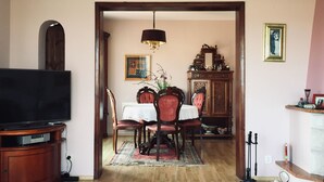 A dining area with a wooden table, chairs, and a chandelier. - an der Kaschubischen Seenplatte by Interhome (Sierakowice)