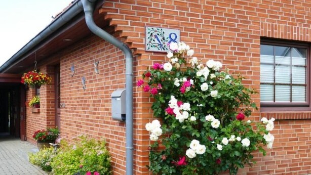 A brick building with a flower box and a mailbox. - Schwalbenring by Interhome (Rövershagen)