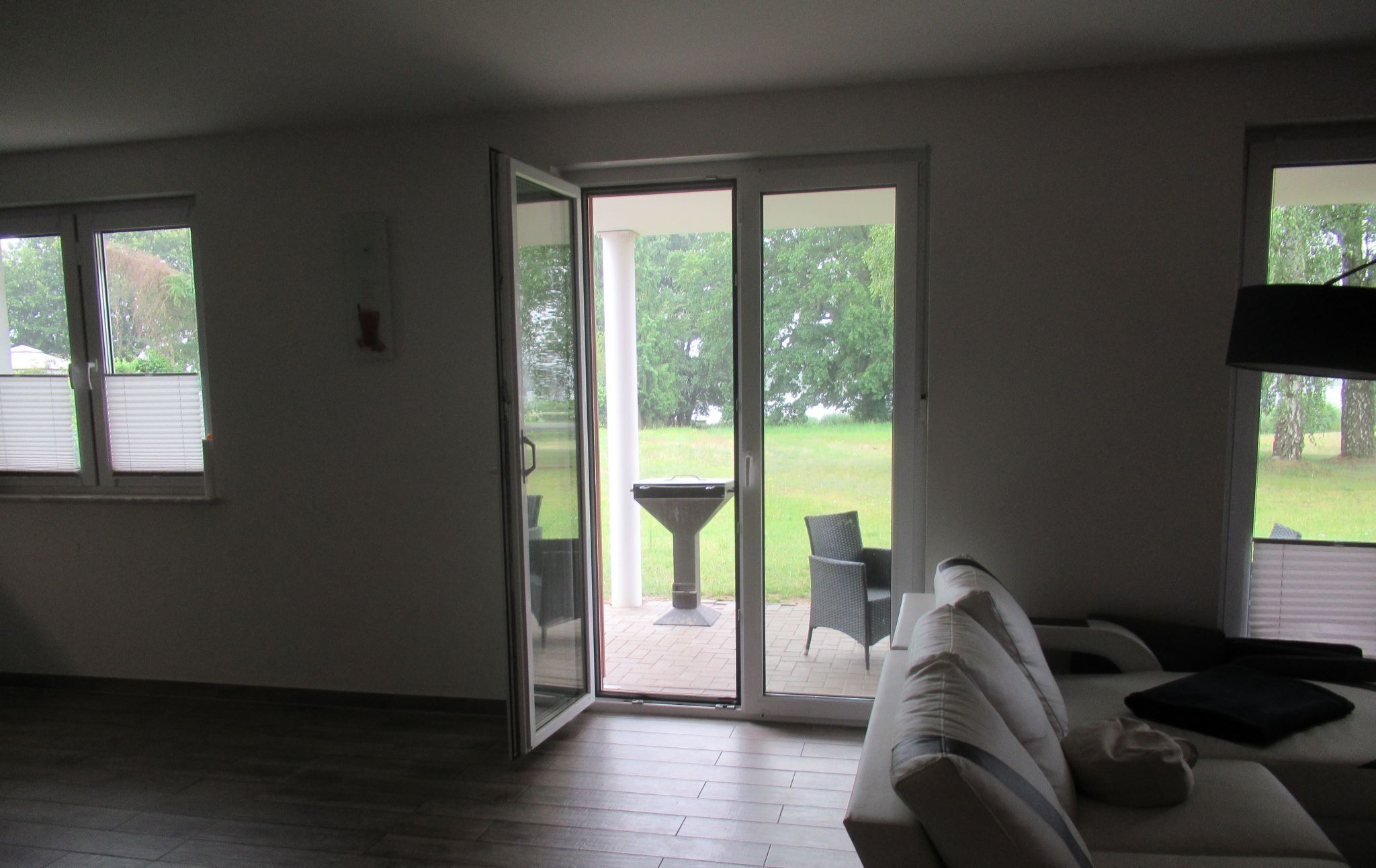 A living room with a sliding glass door leading to an outdoor patio area.