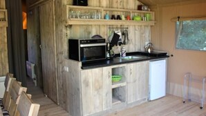 A compact kitchen with a microwave, sink, and cabinets. - Safarizelt in Hohenlychen mit Garten und Grill by Interhome (Lychen)