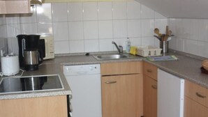 A compact kitchen with a dishwasher, a coffee maker, and a sink. - in Gründerzeitvilla in Strandnähe by Interhome (Ahlbeck)
