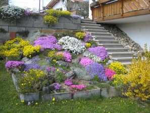 Eine Treppe, umgeben von einer Vielzahl bunter Blumen und Pflanzen.