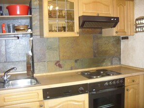A kitchen with a stove, oven, and a sink. - mit Terrasse und Parkplatz by Interhome (Weikersheim)