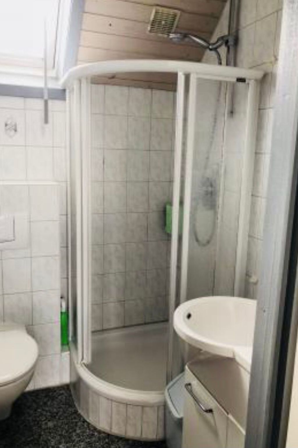 Un bagno con box doccia, toilette e lavandino.