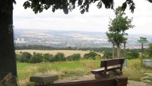 A bench overlooking a cityscape with a view of fields and a distant town. - Apartment Mund by Interhome (Dresden)