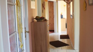 A hallway with a wooden door, a cabinet, and a black mat on the floor. - im Teutoburger Wald by Interhome (Schieder-Schwalenberg)
