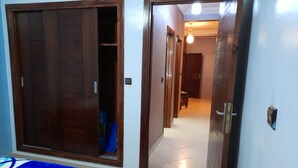 A room with a bed, a wardrobe, and a door leading to another room. - Résidence Annaser 1 by Interhome (Agadir)