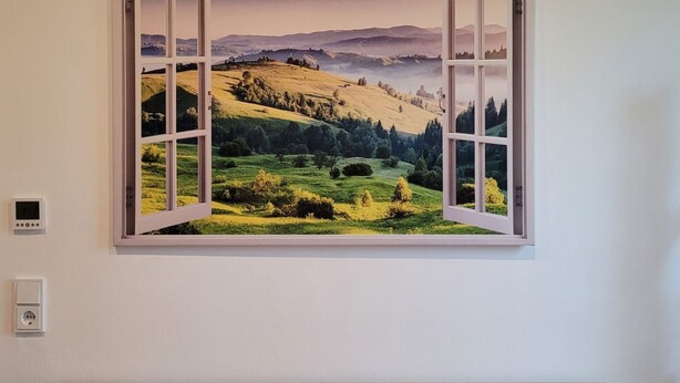 A wall-mounted picture of a landscape with an open window. - Appartement mit Balkon by Interhome (Lasel)