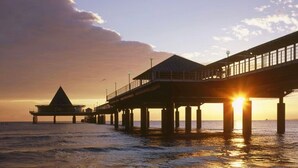 A pier extending into the water with a building at the end. - FH Auf dem Holzweg by Interhome (Bansin)