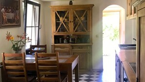 A kitchen with a checkered floor, wooden cabinets, and a dining table with chairs. - Kleines Ferienhaus in Rangsdorf mit großem Garten by Interhome (Rangsdorf)