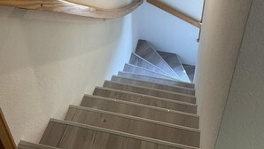 A staircase with wooden handrails and a white ceiling. - im Fachwerkstil mit Sauna und Garten by Interhome (Thomasburg)