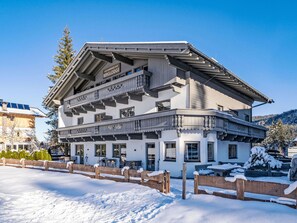 A multi-story building with a balcony, snow-covered ground, and a clear sky. - Appartement "Freiraum" by Interhome (Leutasch)