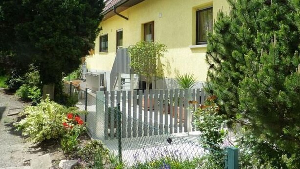 A yellow building with a fenced garden area, a staircase, and a variety of plants. - Mayer in Oberkirch by Interhome (Oberkirch)