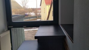 A room with a large window, a black countertop, and a view of a building outside. - Ferien- und Monteurwohnung Nepperwitz Süd by Interhome (Bennewitz)