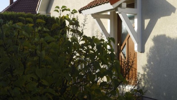 A house with a white exterior, a brown roof, and a window with a wooden frame. - Sassnitz In by Interhome (Sassnitz)