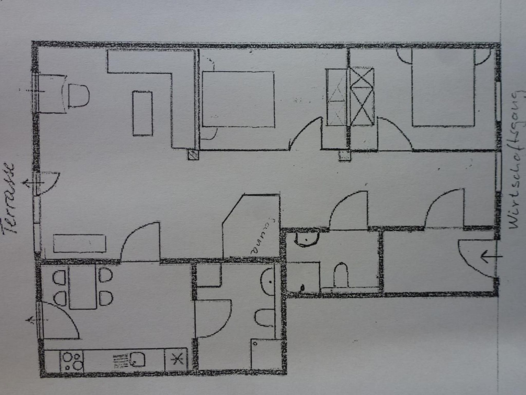 A floor plan of a hotel with multiple rooms, a terrace, and a kitchen area.
