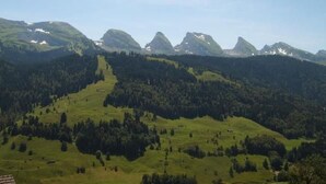 A mountainous landscape with green hills and a clear sky. - Churfirsten by Interhome (Unterwasser)