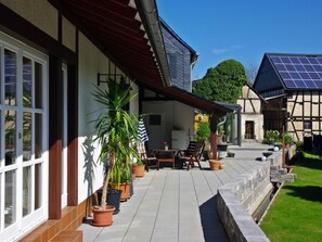 A house with a patio, potted plants, and a solar panel. - Göttert by Interhome (Dickenschied)