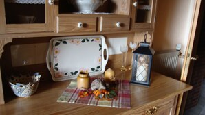 A wooden kitchen counter with a floral-patterned tray, a lantern, and decorative items. - Elztalblick by Interhome (Bereborn)