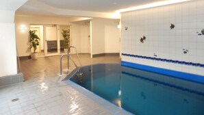 An indoor swimming pool with clear water, a ladder, and tiled walls. - Ostsee Perle by Interhome (Niendorf)