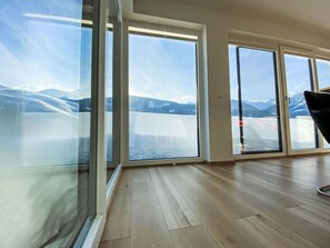 A room with large windows offering a mountain view. - Vacation home  by Interhome (Arnbach)