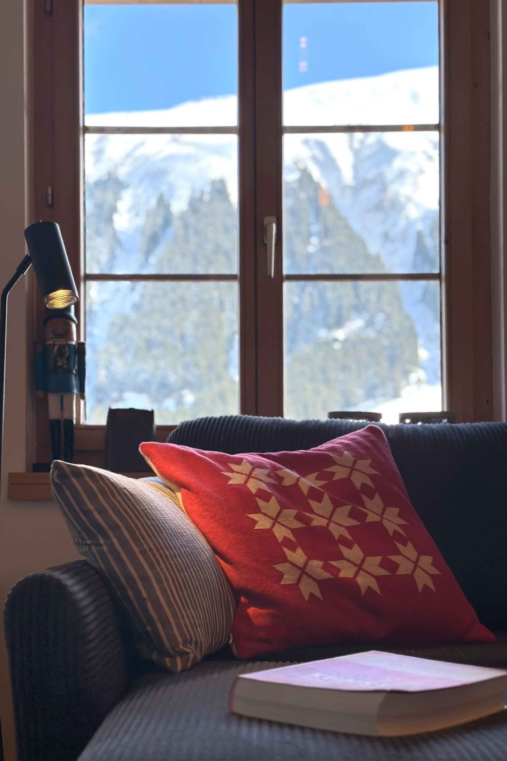 Ein gemütliches Zimmer mit Blick auf einen verschneiten Berg.