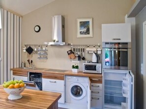 A modern kitchen with a dishwasher, microwave, oven, and a washing machine. - Apartment Teichblick mit eigener Terrasse by Interhome (Klein Meckelsen)