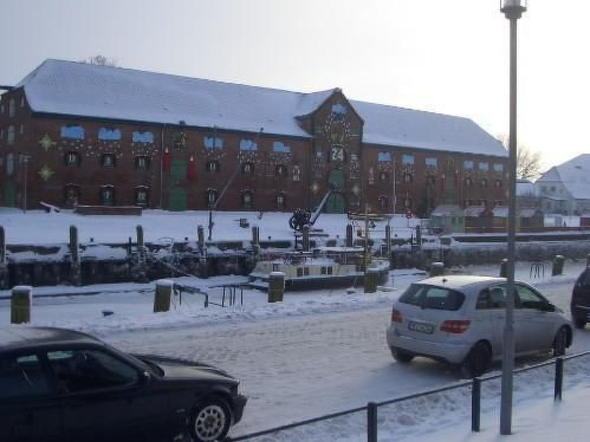 A building with a snow-covered roof and a number '24' on it.