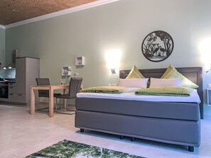 A bedroom with a bed, a desk, and a chair. - Studio Appartement Gartenblick by Interhome (Elskop)