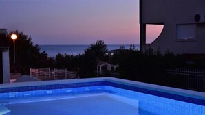 A swimming pool with a view of the sea at dusk. - Villa Luger 1. OG by Interhome (Rogoznica/Ražanj)