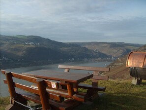 Ein Holztisch mit einem Kettenvorhängeschloss mit Blick auf einen Fluss und Hügel.