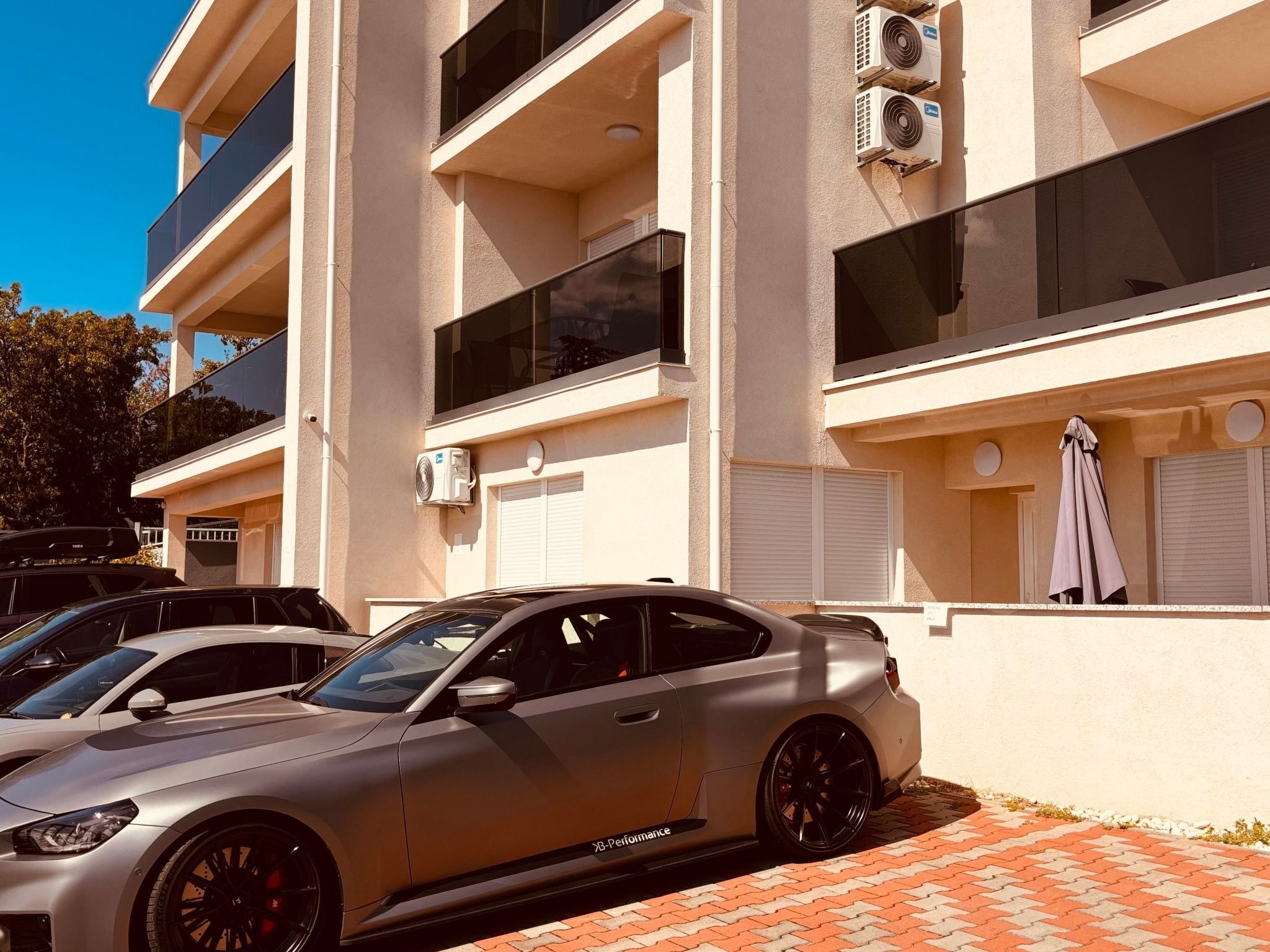 A modern building with a car parked in front.
