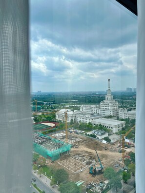 A large building with a prominent tower, surrounded by construction sites and greenery. - Sunny Residence (Ha Noi)
