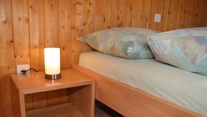 A wooden bunk bed with a nightstand and a lamp. - Sutter in Brülisau bei Appenzell by Interhome (Brülisau)