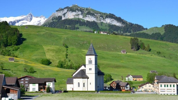 A rural village with a church, houses, and a mountain in the background. - Sutter in Brülisau bei Appenzell by Interhome (Brülisau)