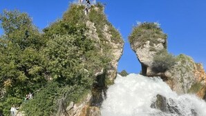 A waterfall cascading over rocky terrain with a viewing platform and visitors. - South Beach Apartment 10km Rheinfall by Interhome (Hemmental)
