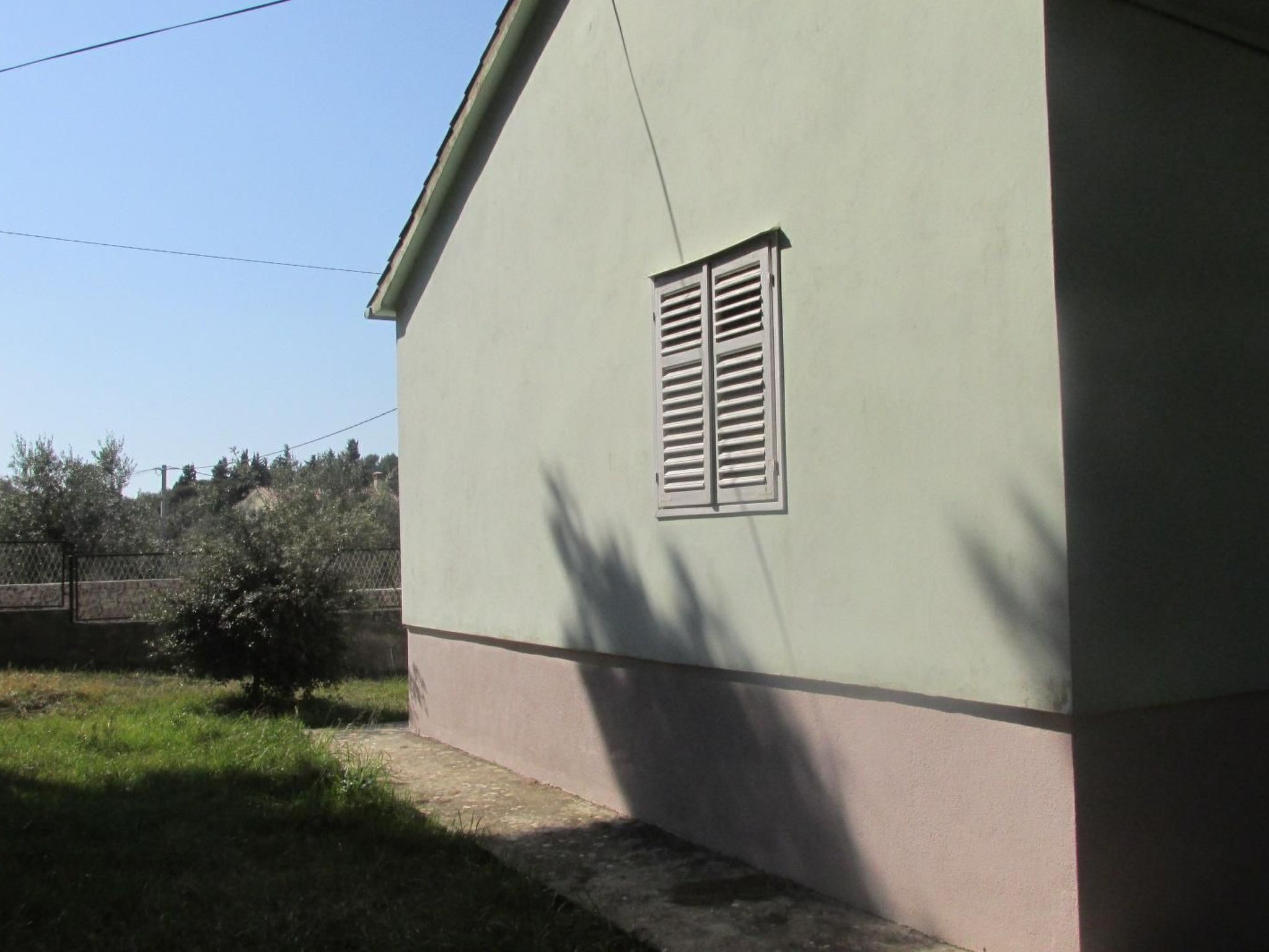 A building with a small window and a sloped roof.